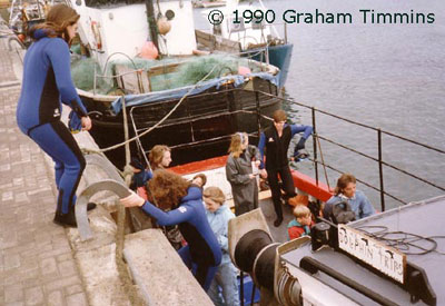 Seventh Wave customers boarding Bruce Flannerys hastily converted dolphin boat. No pontoons or easy access ramps in 1990!